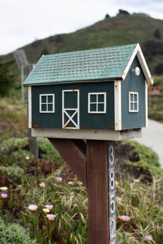 Rustic wooden birdhouse-style mailbox 